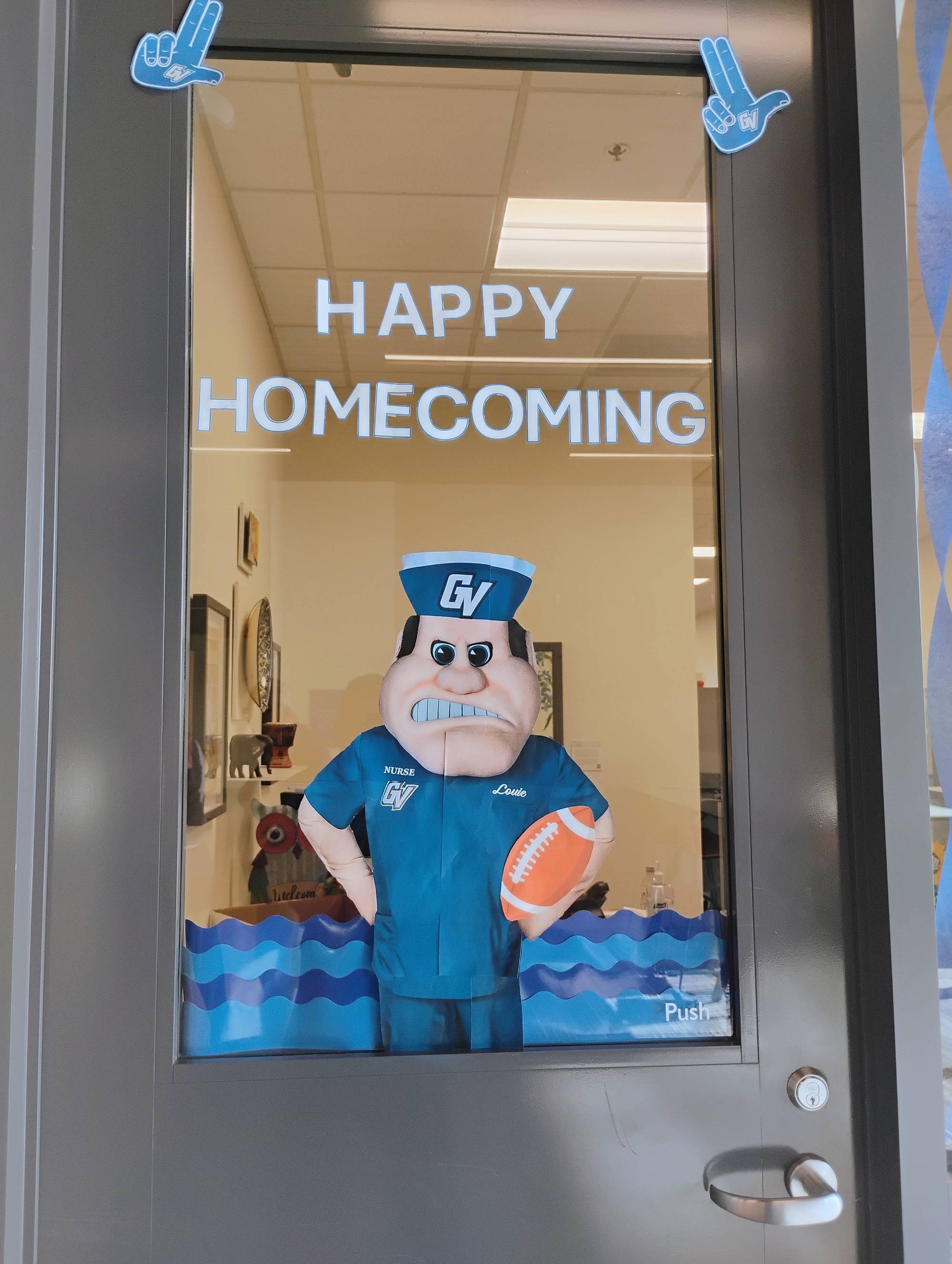 KCON Homecoming decorations, front door with Louie cutout saying "Happy Homecoming"